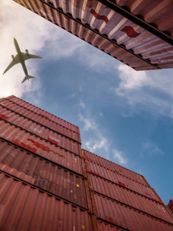 Airplane flying above container logistic. Cargo and shipping business. Container ship for import and export logistic. Logistic industry from port to port. Container at harbor for truck transport.